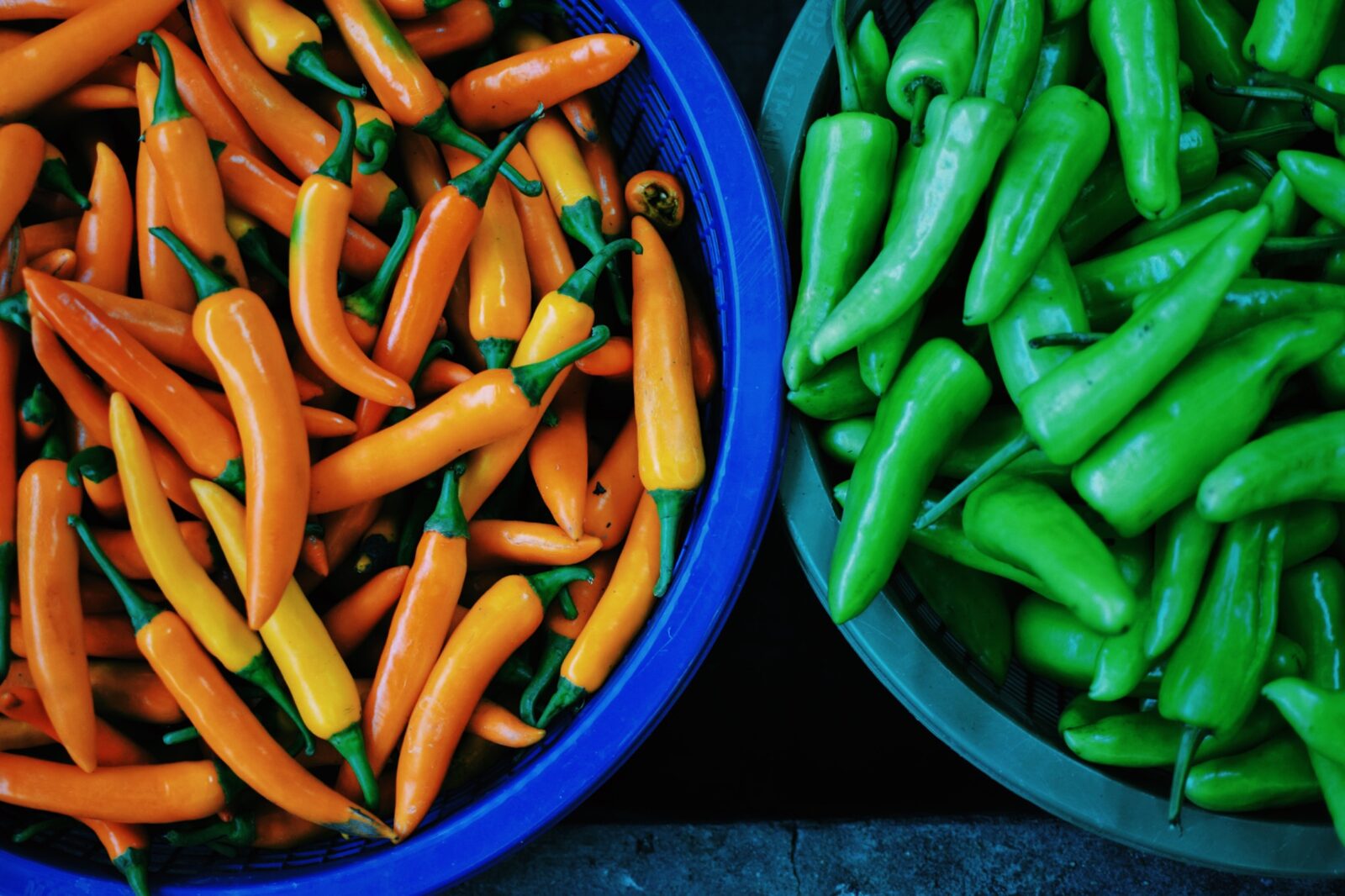 Baskets of red and green chiles at the market